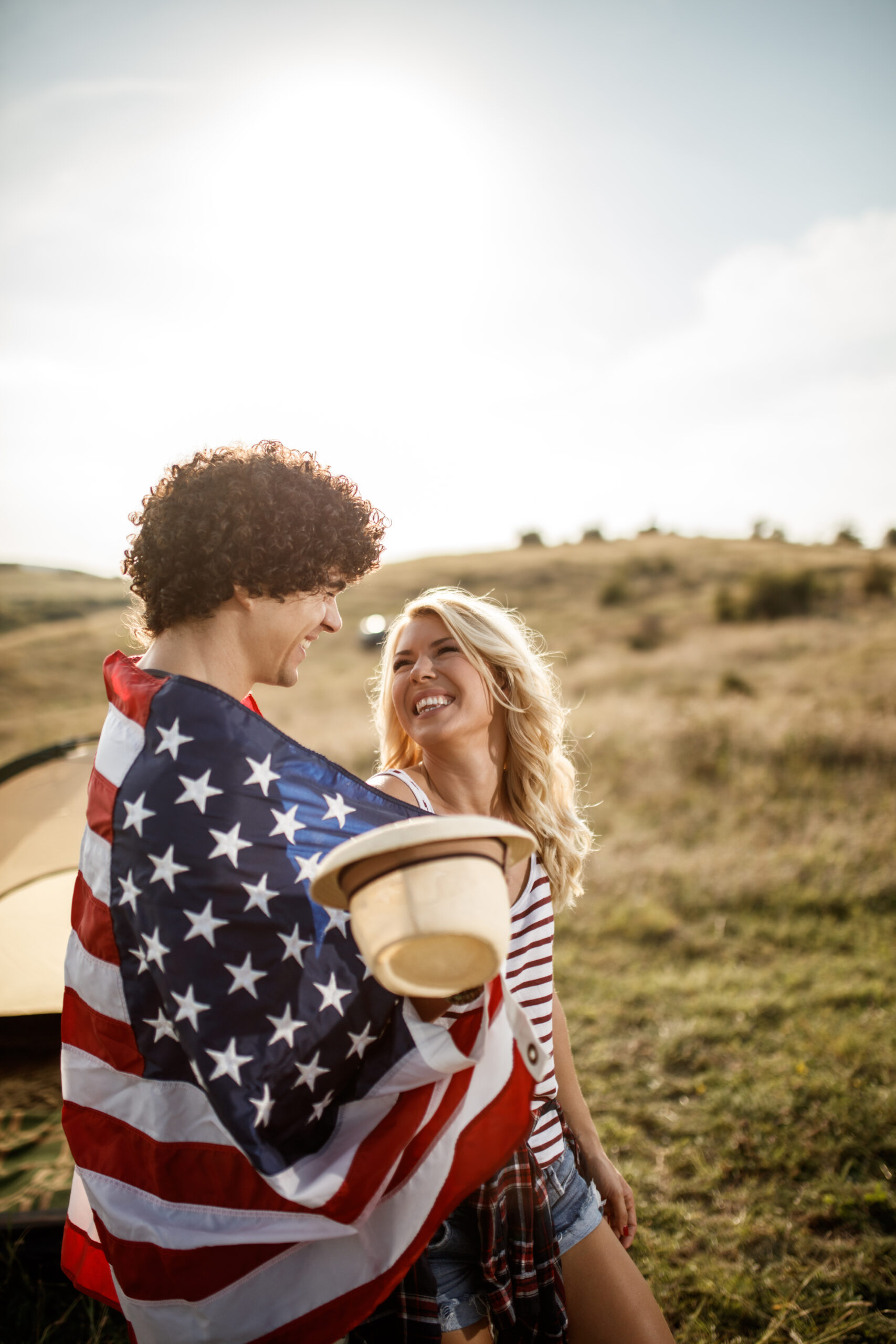 An ecstatic couple smiling because they learned about how non-qm DSCR loans and bank statement jumbo loans can enable them to achieve and live their American Dream.
