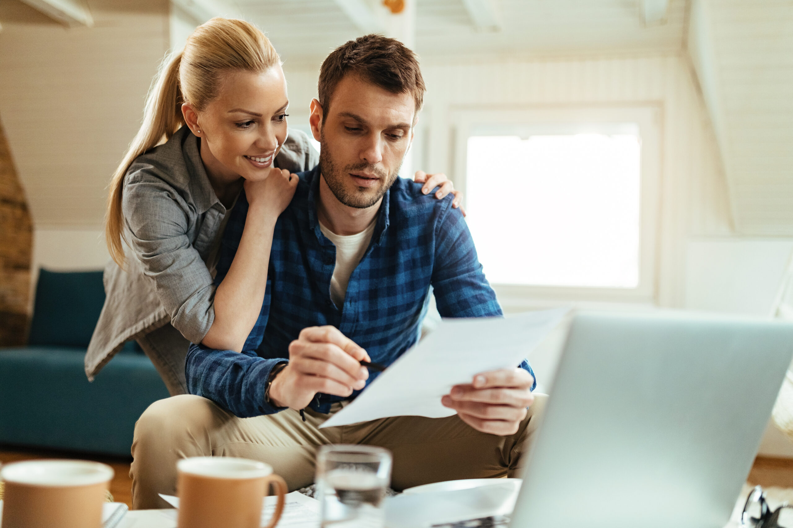 A couple smiling after learning the answer to the question, What’s the difference between a home equity line of credit and a closed-end second mortgage?