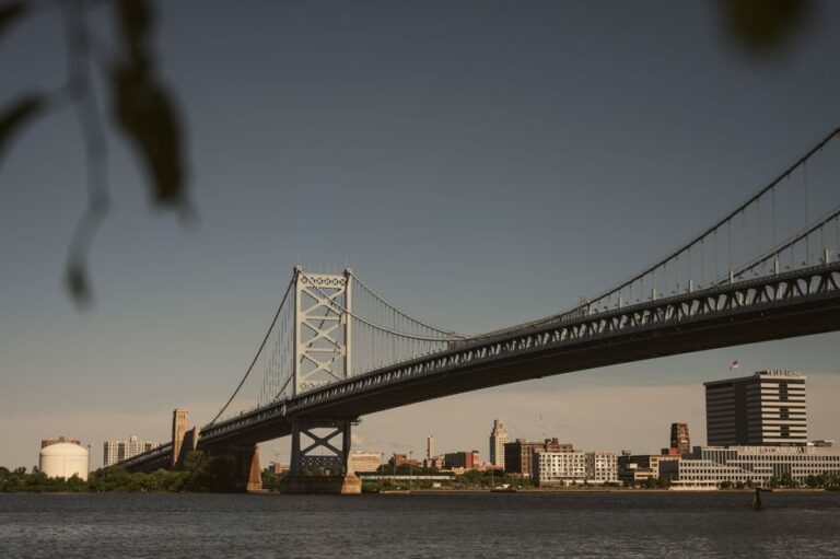 Scenic view of the Ben Franklin Bridge spanning the Delaware River with Philadelphia skyline in the background.