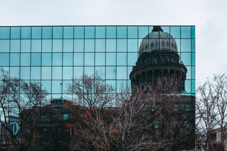 Reflection of Idaho State Capitol in a mirrored building facade in Boise, ID.