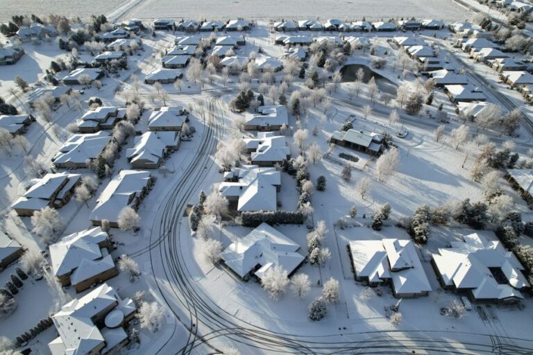 Aerial shot of a snow-covered suburban neighborhood in Eagle, Idaho, during winter.