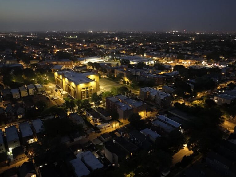 Aerial photograph capturing Chicago's urban landscape illuminated at night.