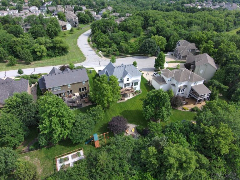 Aerial image showcasing a lush suburban neighborhood with well-maintained lawns and houses.