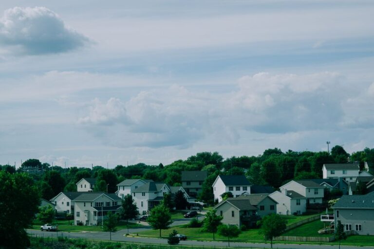 Picturesque suburban houses beneath a blue sky with clouds in Wisconsin.