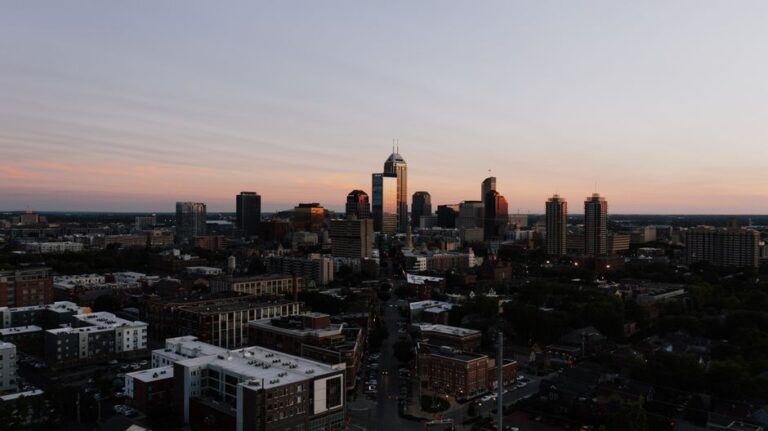 A stunning aerial view of Indianapolis skyline during sunset, showcasing urban architecture.