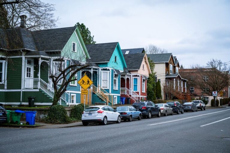 Picturesque street view of colorful, charming houses in a Portland, OR suburb, showcasing urban living.