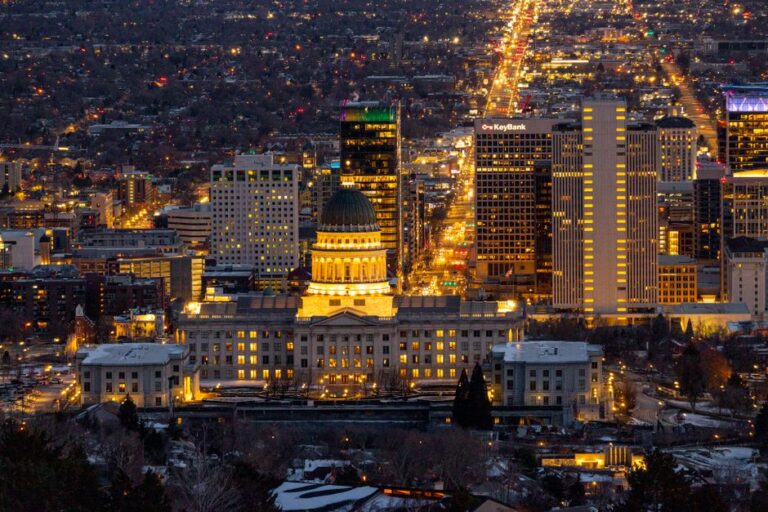 Stunning aerial view of Salt Lake City skyline featuring the Utah State Capitol illuminated at night.